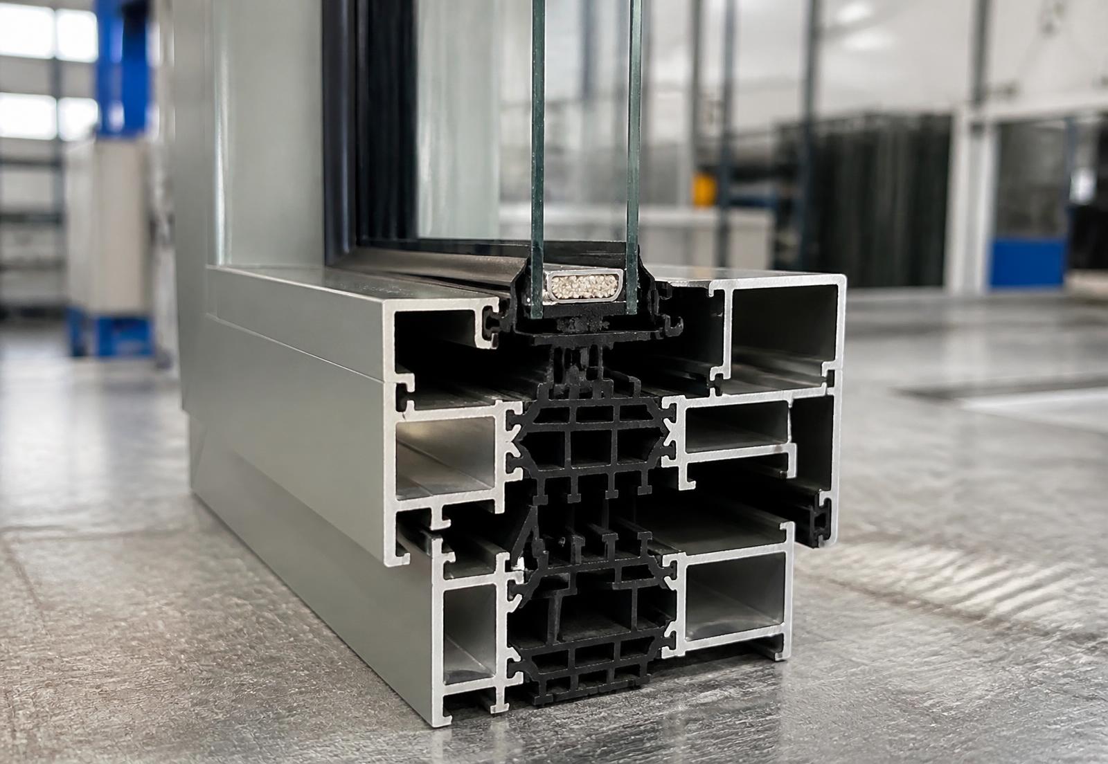 Cut-away section of a thermally broken aluminum window frame showing the polyamide break and insulated glass edge